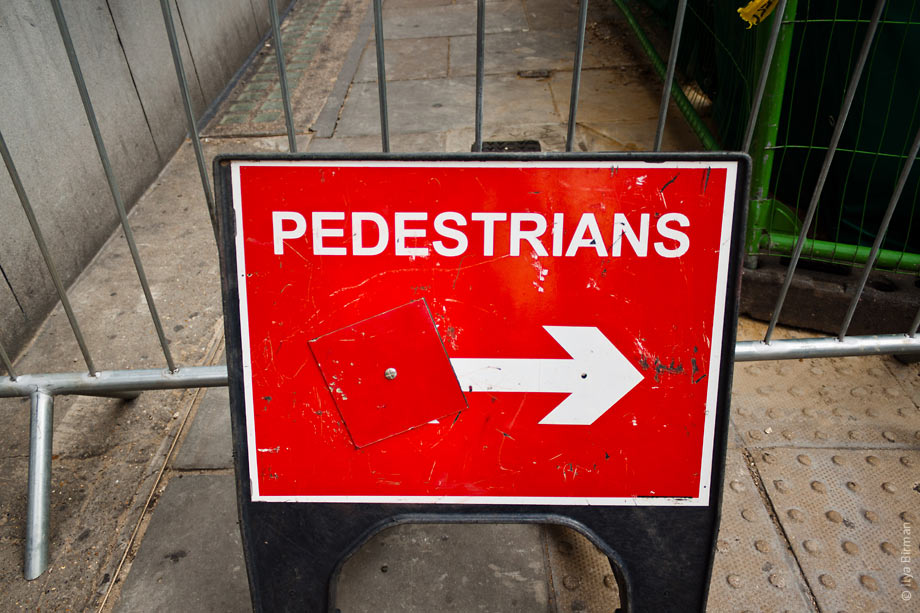 Pedestrians are guided around a contruction site in London