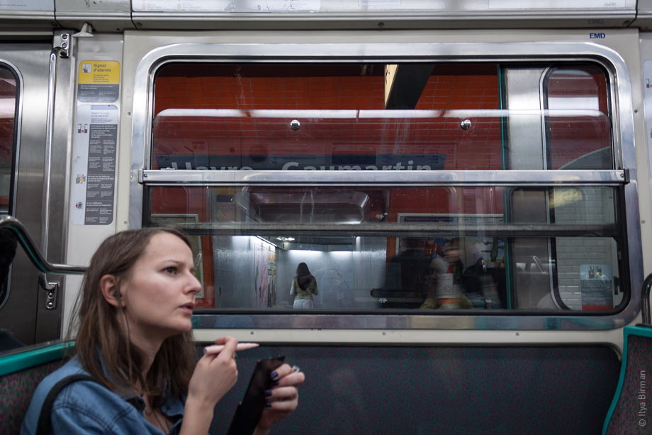 The girl takes a break in dolling herself up to make sure she will not miss her station