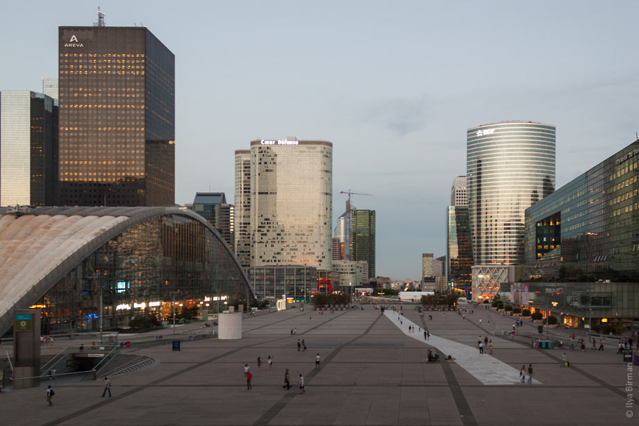 In front of the Grande Arche in Paris, there is a square with a huge white stripe